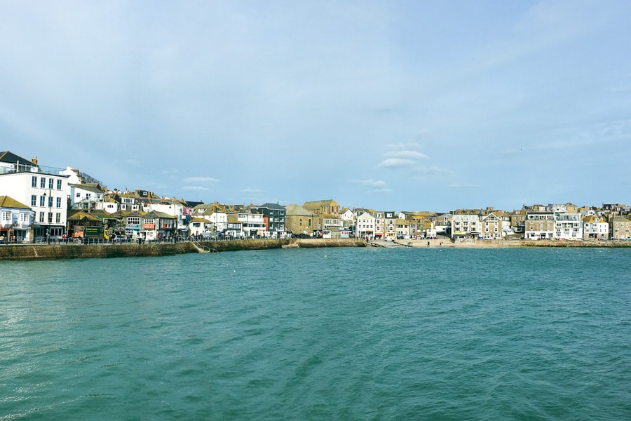 Looking across water to houses and buildings lining the shore of St Ives.
