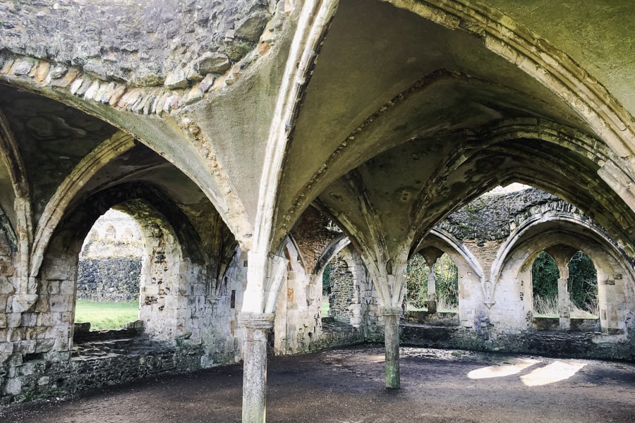 Stone ruins and arches of ancient Waverley abbey on our England itinerary.