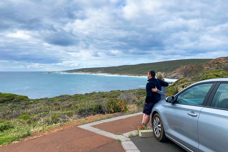 John and Dan lean against a car looking out over a bay in South West WA.