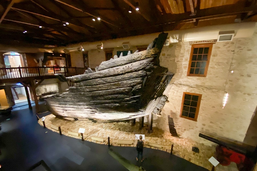 Dan looks small next to a huge preserved section of the shipwreck Batavia at the WA Shipwrecks Museum in Fremantle.