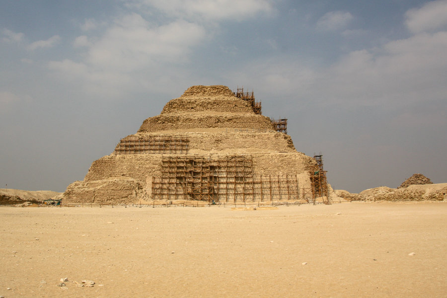 The ancient step pyramid of Djoser rises in six tiers from the desert sand, a key stop on our itinerary for Egypt. 