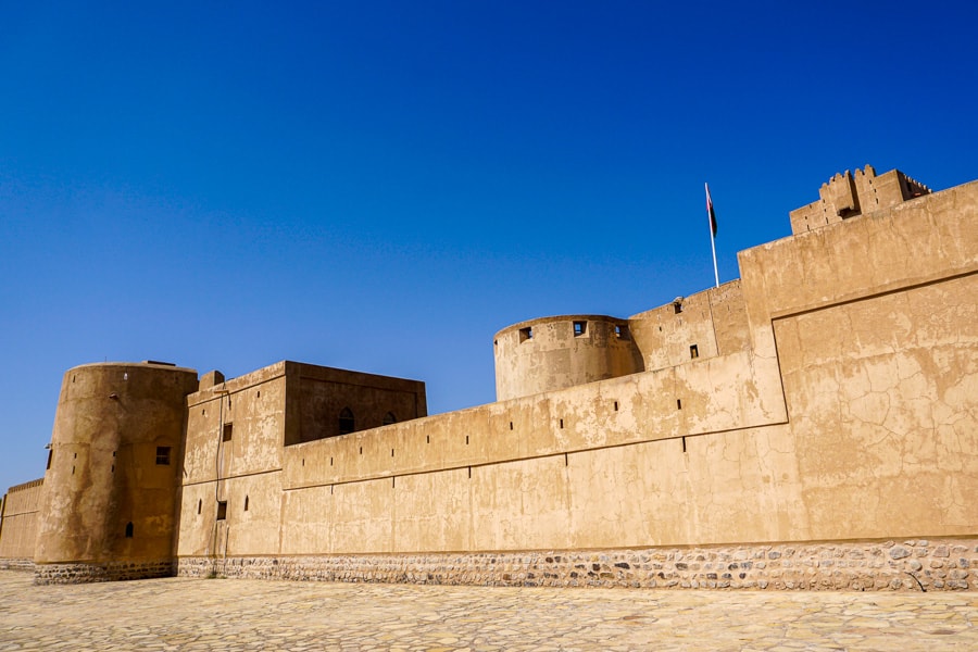 Imposing Jibreen Castle dominates the desert landscape, a highlight of our self drive Oman 2 week itinerary.