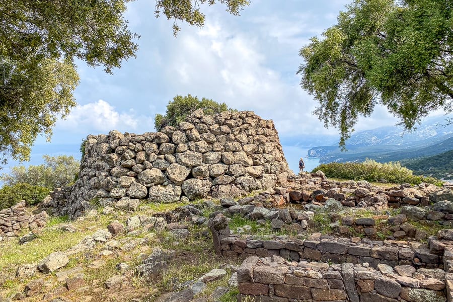 Crumbling Nuraghe Mannu still manages to look imposing as a tourist looks out across the Gulf of Orosei.