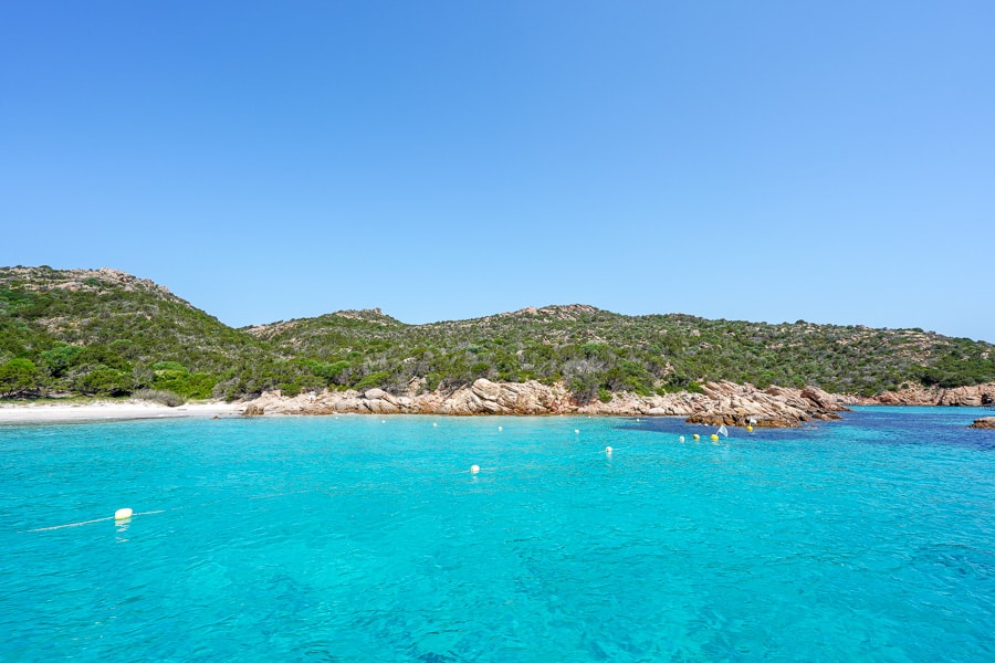 Crystal clear turquoise ocean surrounds the granite, rocky outcrops that make up the La Maddalena archipelago. 