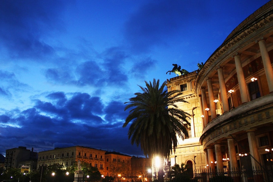 Night falls over the circular Teatro Politeama, a highlight when visiting Palermo. 