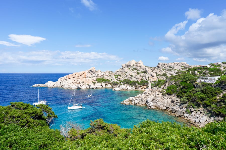 Capo Testa’s granite rocks starkly contrast the azure ocean dotted with sailboats. A highlight of our Sardinia road trip.