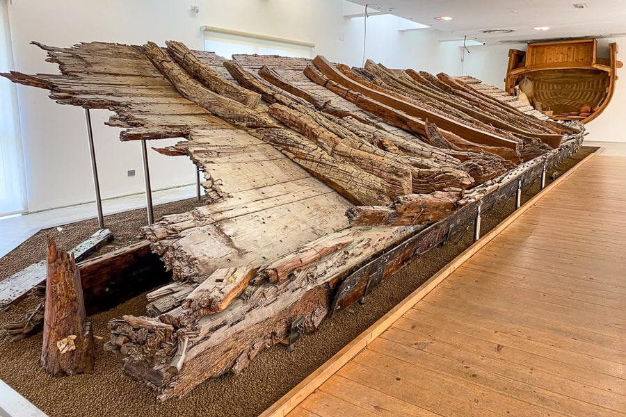 A well-preserved ancient Roman cargo ship at the Museo Archeologico di Olbia, a stop to include on your Sardinia itinerary.