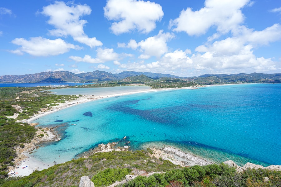 Incredible views of the turquoise bay of Spiaggia di Porto Giunco a must see on your Sardinia road trip.