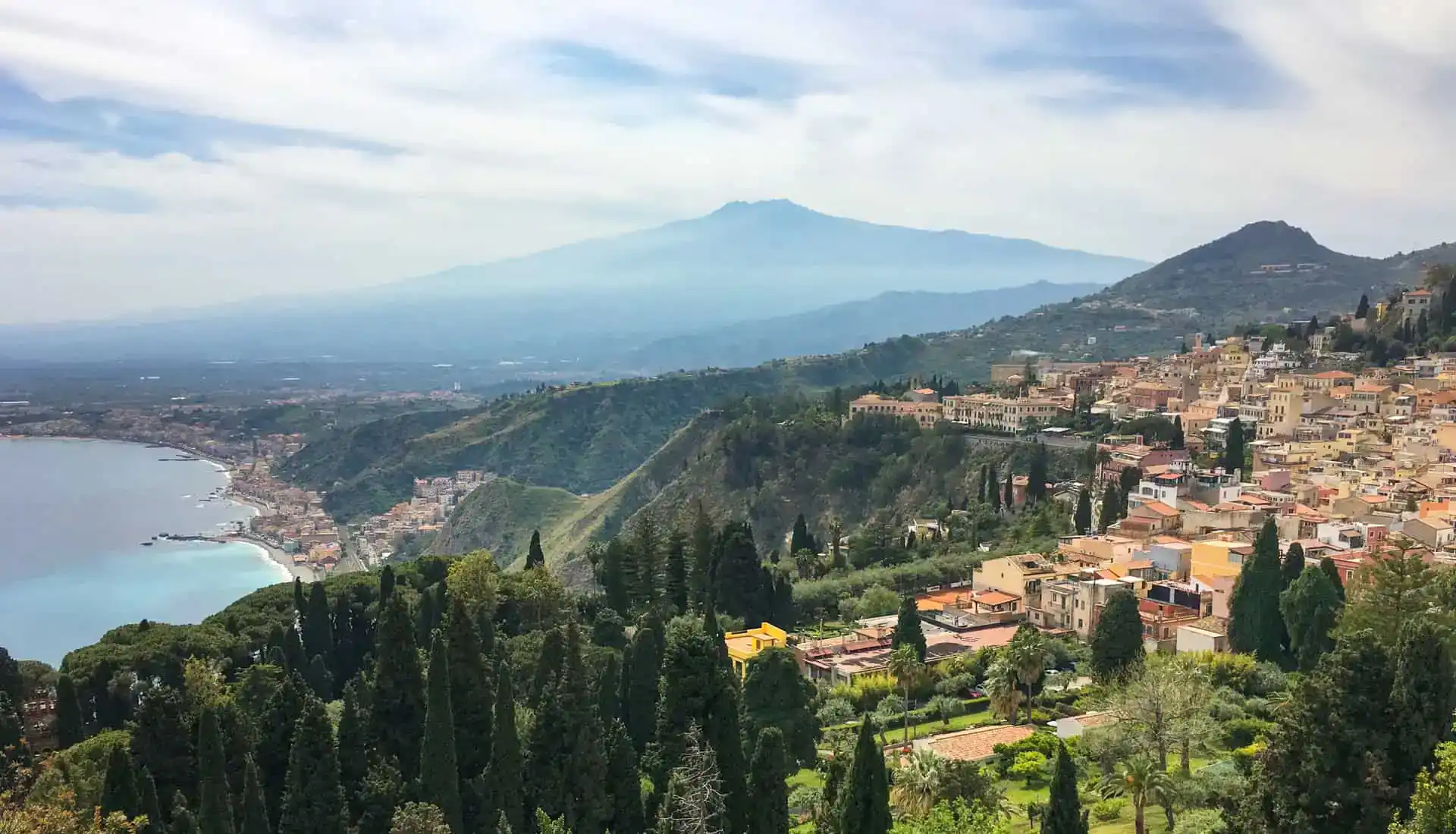 Sweeping views past buildings and coastline to Mount Etna on Day 11 of Sicily road trip.