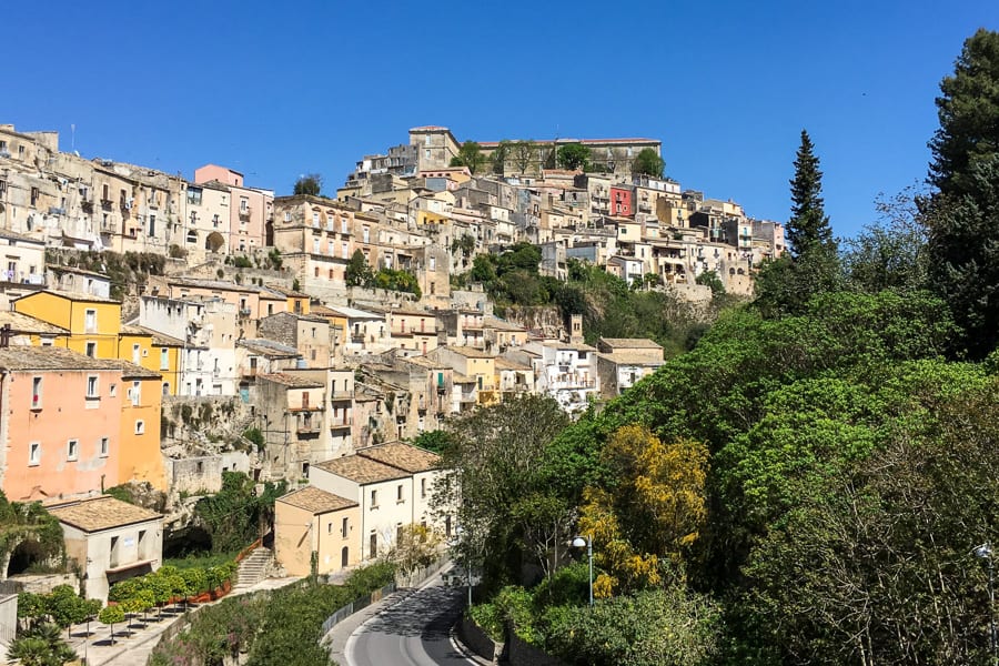 The old houses of Ragusa rise in tiers and shades of yellow. 