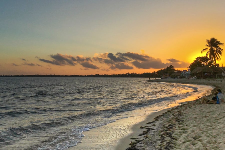 A couple enjoy sunset on the beach at Playa Larga, a highlight of 2 weeks in Cuba.