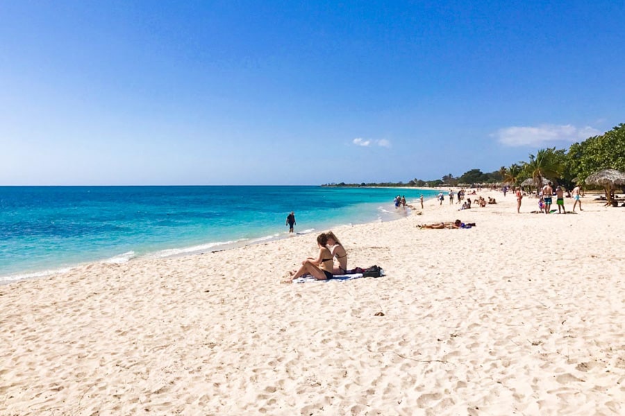 Aqua coloured water meets white sand at Playa Ancon, one of the best places to visit in Cuba for a beach escape.