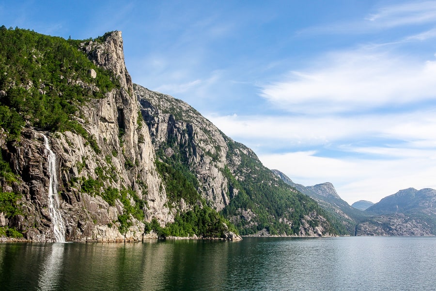 Views of a waterfall on Lysefjord seen from the car ferry on a sunny day from Lauvvik to Lysebotn on our Norway road trip.