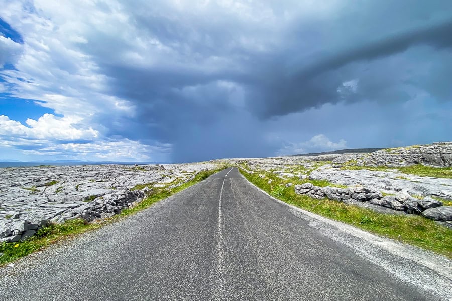 A dark cloud gathers over the road through the Burren’s karst terraces near the Poulsallagh Lookout.