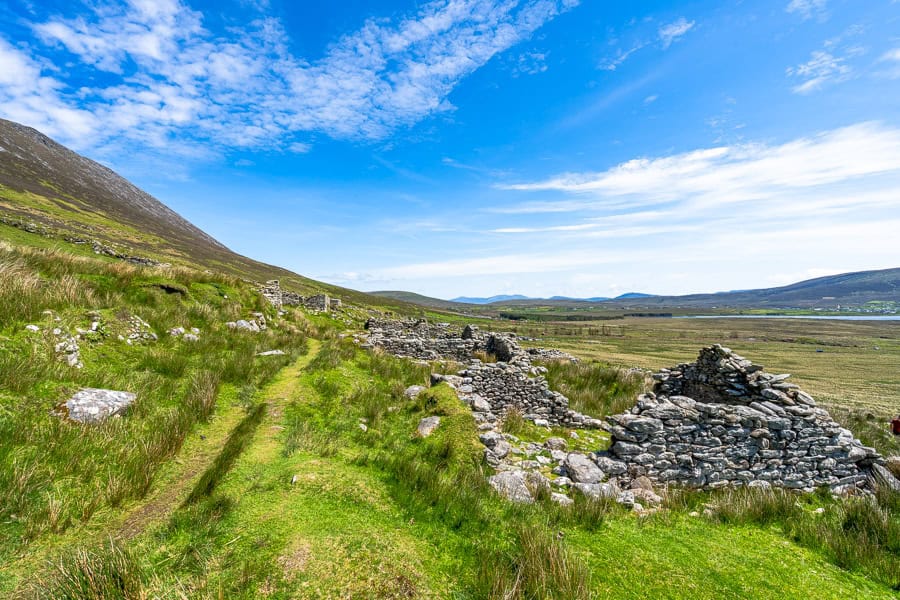 Nature slowly reclaims Slievemore Deserted Village on the slopes of Slievemore Mountain.