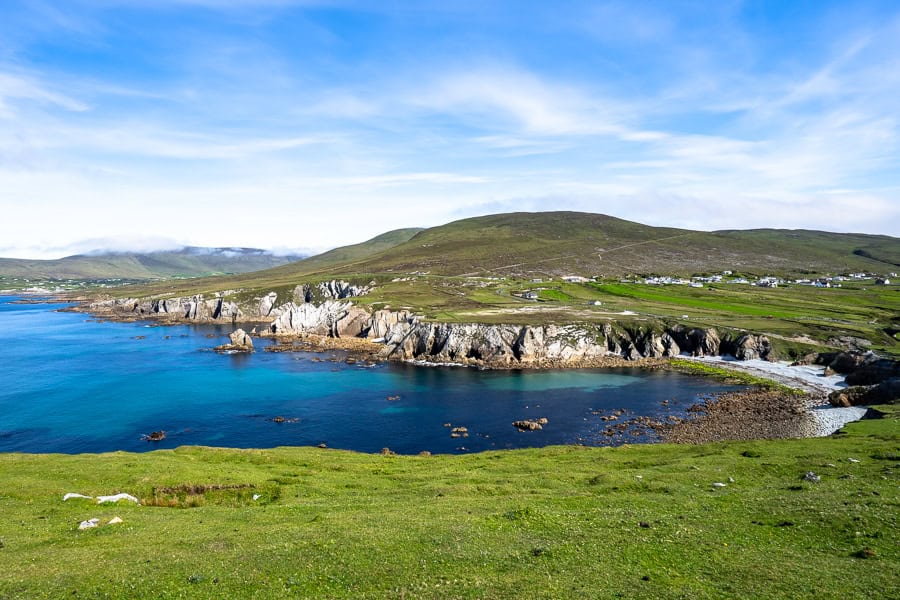 View of Ashleam Bay, with steep cliffs and sparkling water from the Wild Atlantic Way Discovery Point at Cuan na hAisléime.