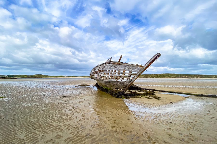 Bunbeg Beach Shipwreck is exposed at low tide - one of the more unique attractions to be explored while visiting Ireland.