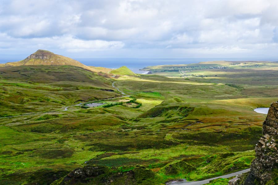 High view from the Quiraing across green hills to Staffin and the sea.