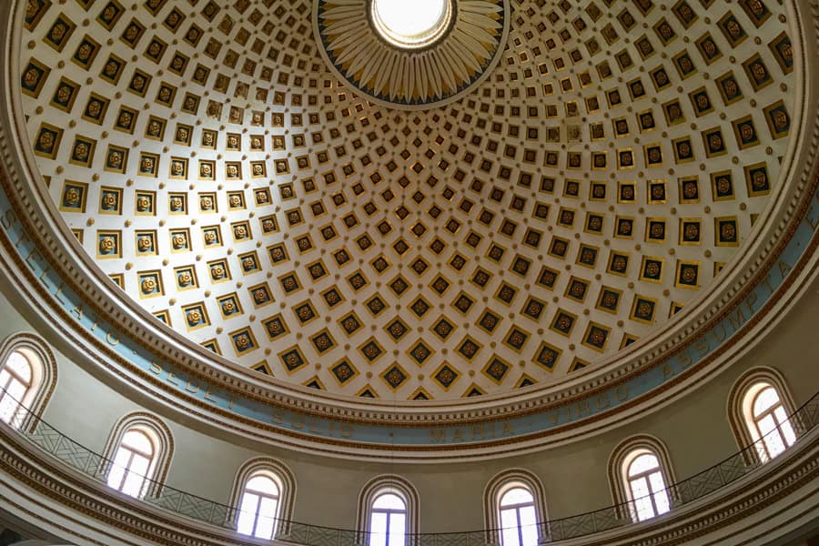 Looking up at a vast dome with windows underneath while visiting Malta.