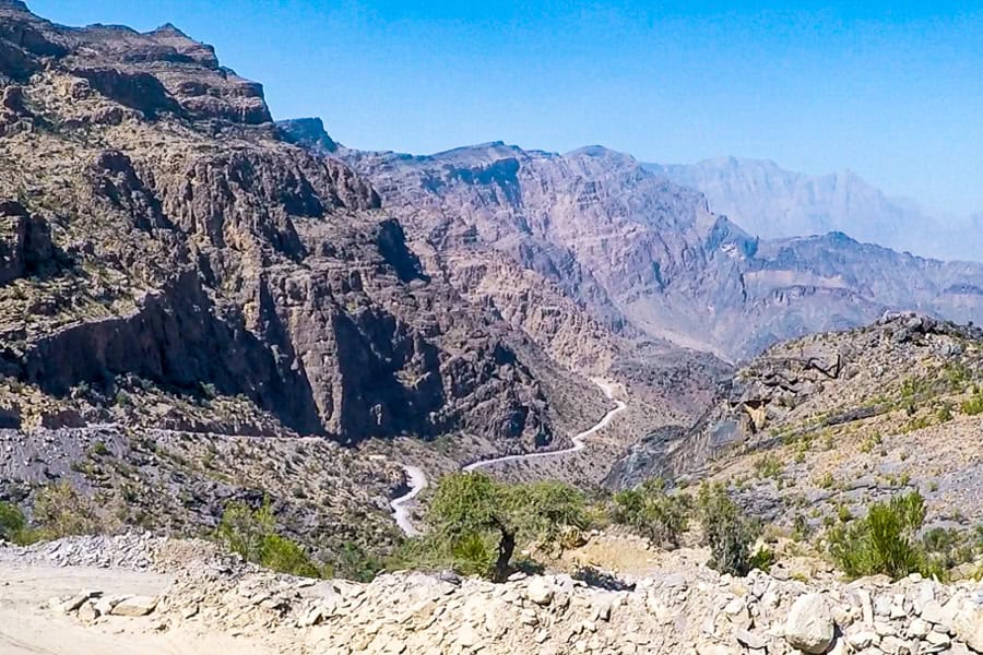 Expansive views of the parched, winding Al Hajar mountain pass, a good reason to get an Oman 4x4 rental.