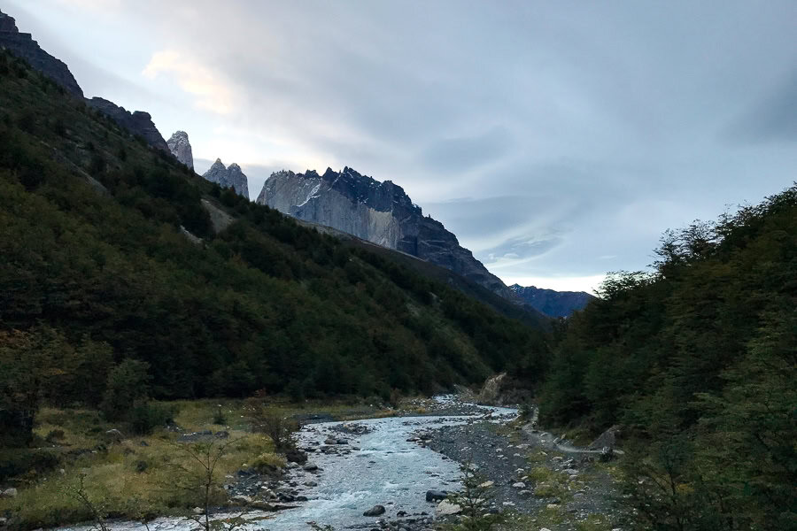 A river winds through the foreground and peaks rise in the background at Chileno on our self-guided W trek.