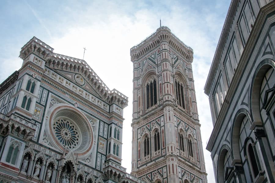 Looking up at the cathedral, bell tower and baptistery of the Duomo Complex, major stop on a Florence itinerary.