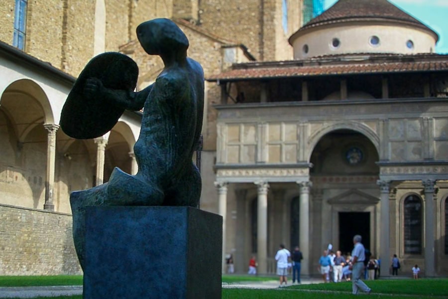 3 Day Florence Itinerary: A modern statue of a person holding a shield in front of an old building.
