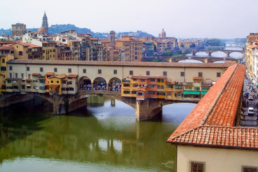 Florence attractions, the Ponte Vecchio topped by the Vasari Corridor, cross the River Arno.