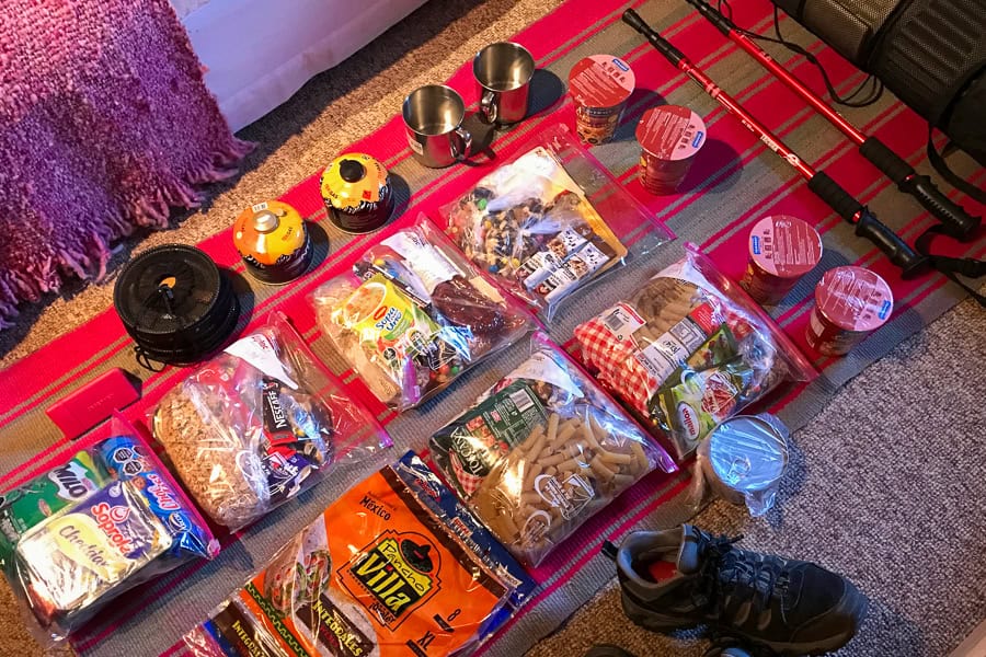 Bags of food laid out on a floor ready for packing ahead of our W trek self guided trip.