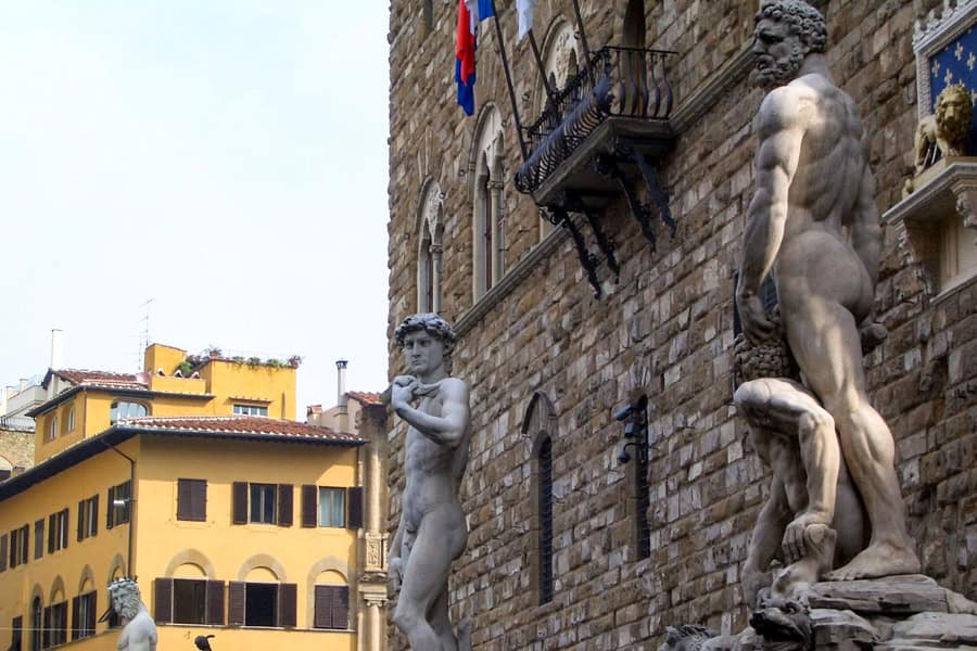 Sculptures stand guard outside the stone Palazzo Vecchio, key stop on our itinerary for Florence.