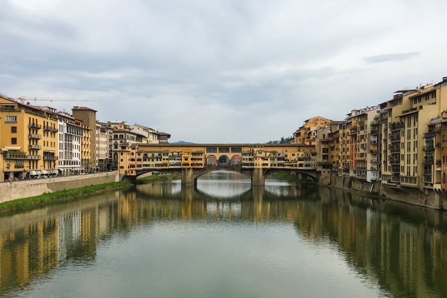 3 Day Florence Itinerary: Ponte Vecchio crosses a river with buildings on each side.