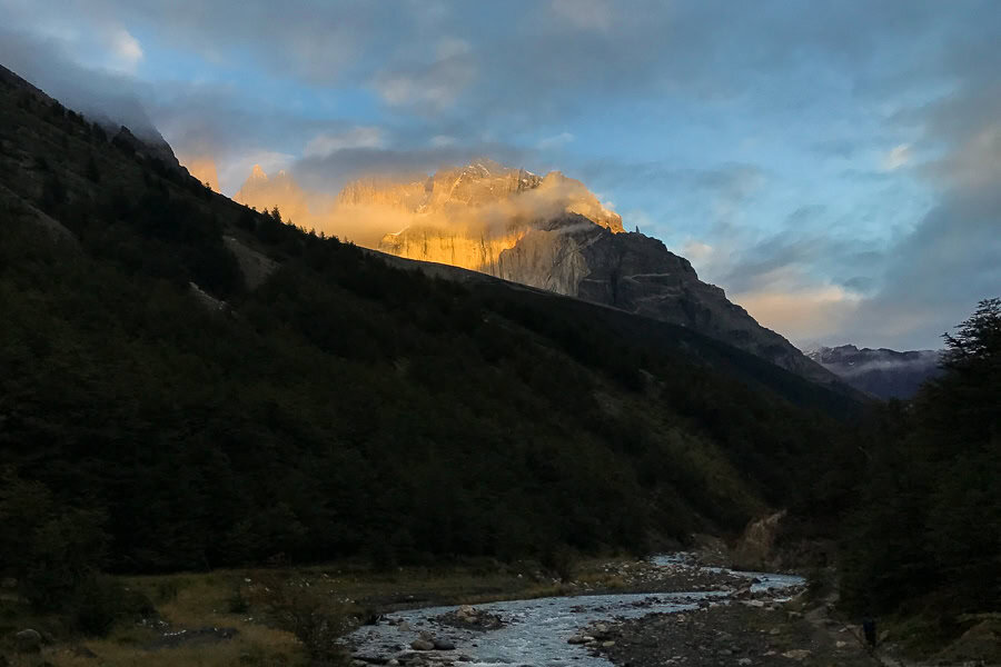 Morning sun blasts onto the distant Las Torres peaks in Torres del Paine.