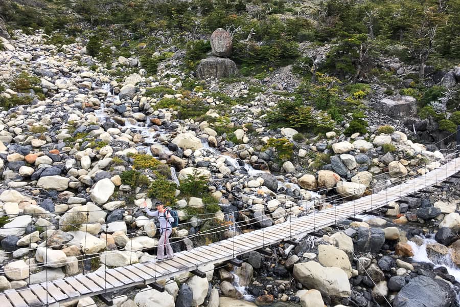A swing bridge crosses a river on the W Trek Patagonia.