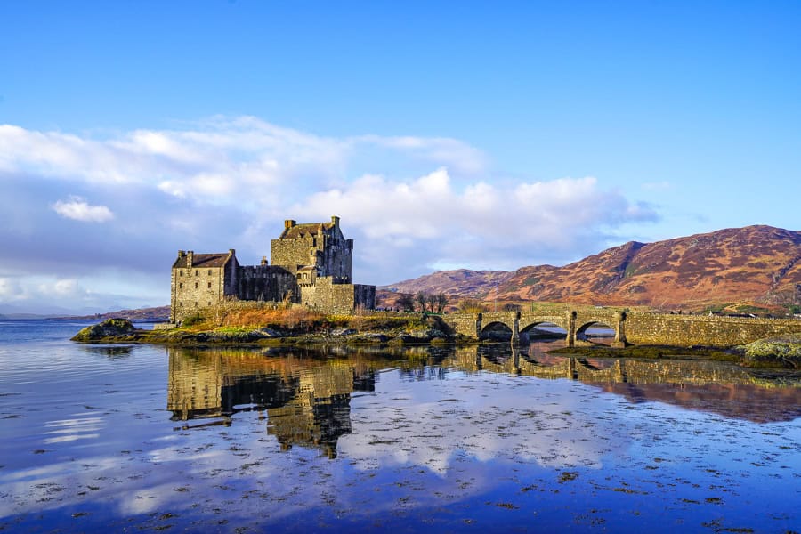 The calm waters of Loch Duich perfectly reflect Eilean Donan Castle – a diversion from the classic North Coast 500 itinerary.