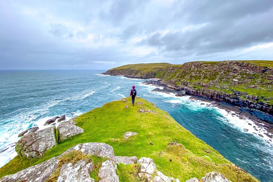 Rough seas batter a windswept Stoer Head looking towards coastal cliffs – a highlight of our North Coast 500 itinerary.