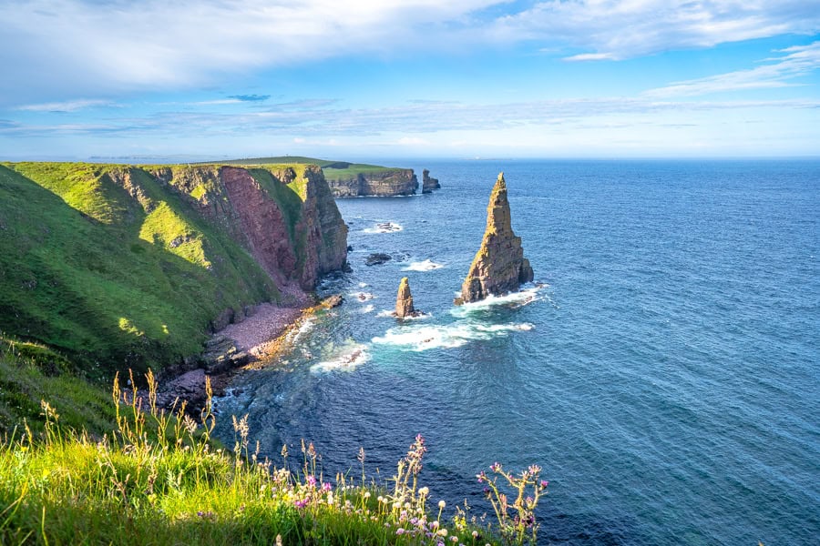 Views along grassy coastal cliffs to Duncansby Stacks during our north coast 500 road trip.