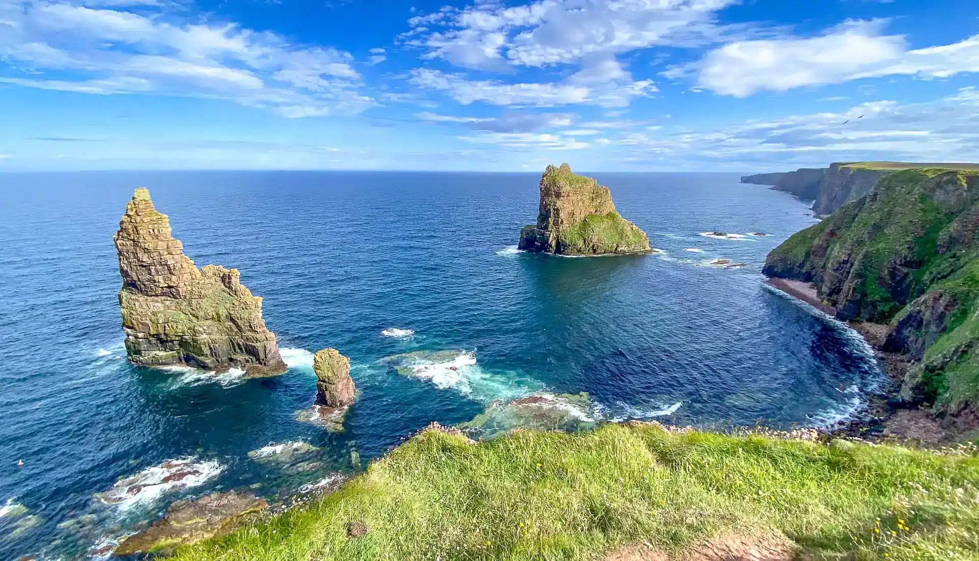 Views of Duncansby Stacks in the Scottish Highlands in perfect sunshine, a highlight of a NC500 road trip.
