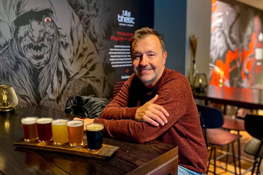A visitor enjoys a paddle of local beers at the Uil Bheist Distillery and Brewery in Inverness.