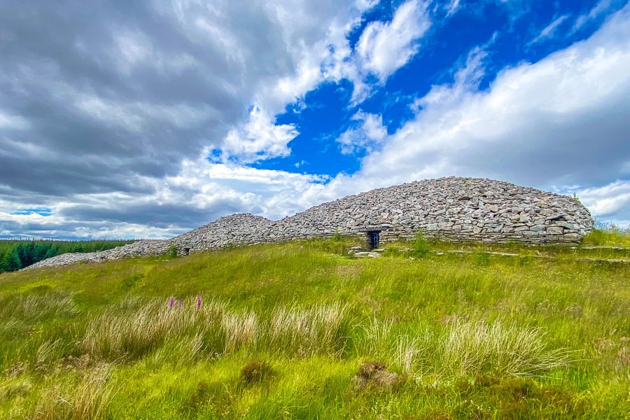 The Grey Cairns of Camster sit on a windswept hill in perfect sunshine – a highlight of Day 1 of our NC500 road trip.