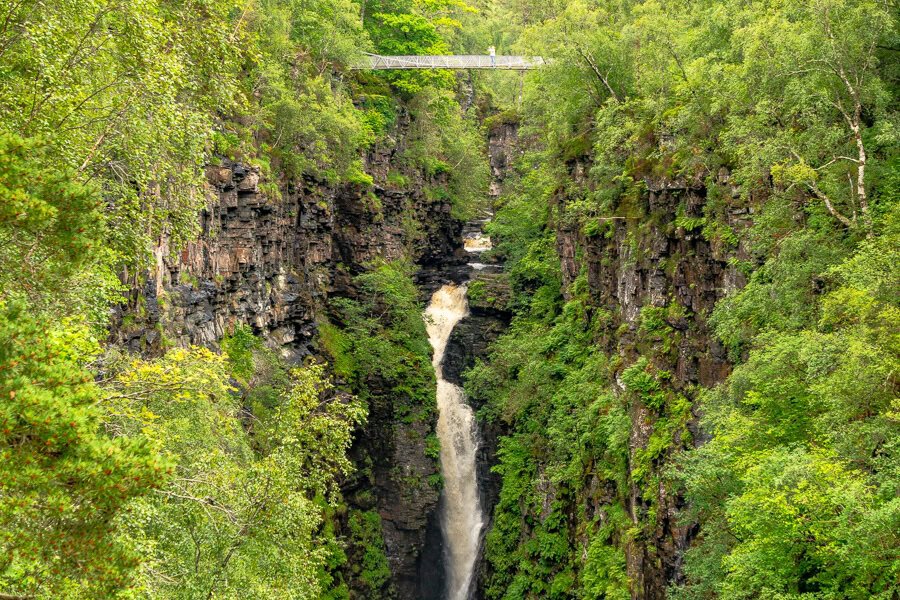 Views of tree lined Corrieshalloch Gorge towards the suspension bridge over the Falls of Measach.