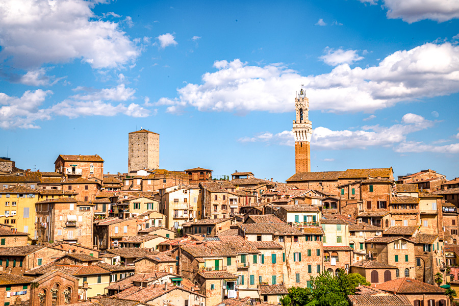 View across the rooftops of Siena towards the Torre del Mangia, one of the most spectacular hill towns in Tuscany.