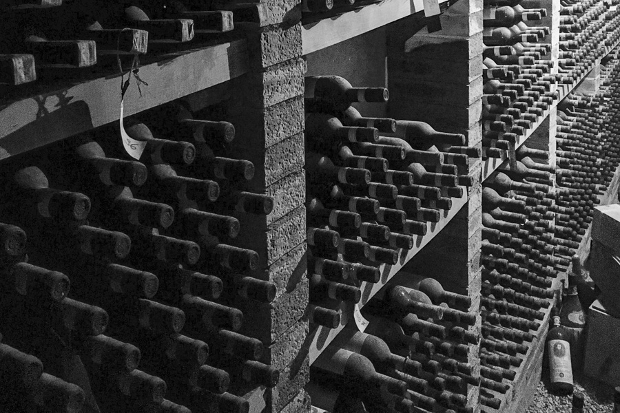 A rack of dusty wine bottles at a vineyard in Chianti, visited as we road trip Tuscany and the hill towns of Italy.
