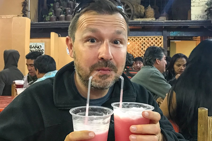 Drinking two colourful terremoto cocktails through straws while visiting Santiago – Chile's very strong national drink.