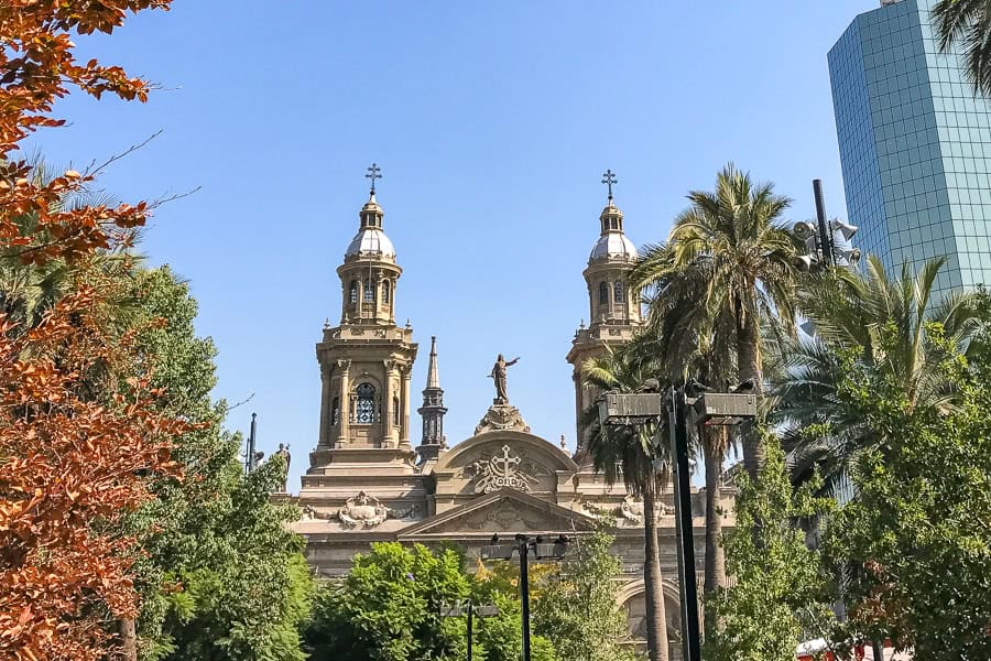 Cathedral Metropolitana in Santiago with autumn trees and high rise buildings - another of the top things to do in Santiago.