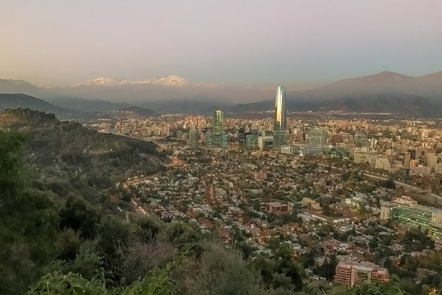 The snow-capped Andes rise behind Gran Torre Santiago – a place that’s definitely on our next Santiago itinerary.