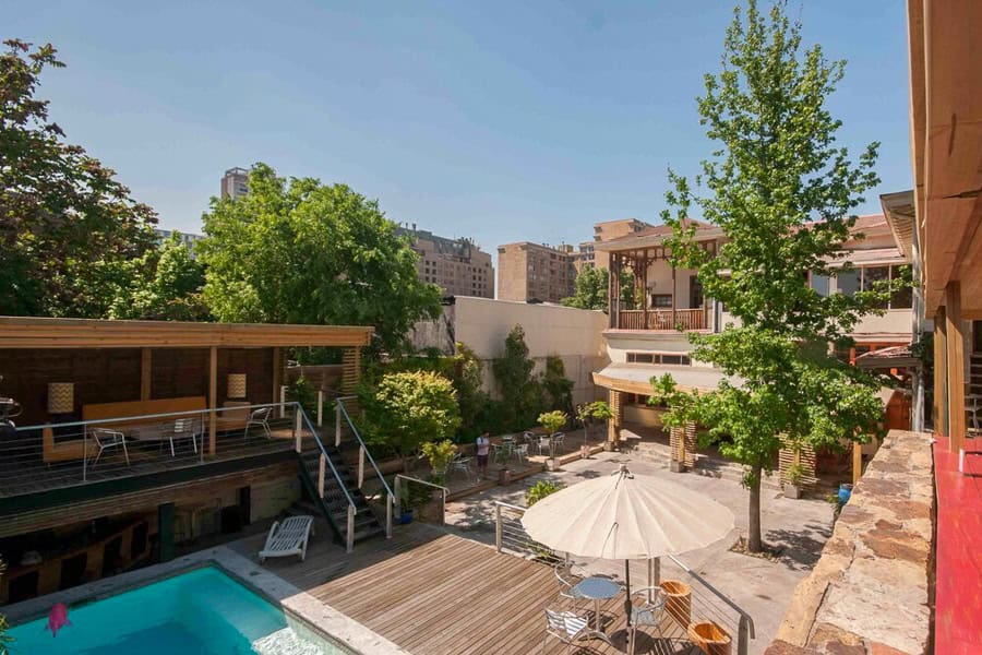 View across the courtyard and pool area at Happy House Hostel in Santiago.