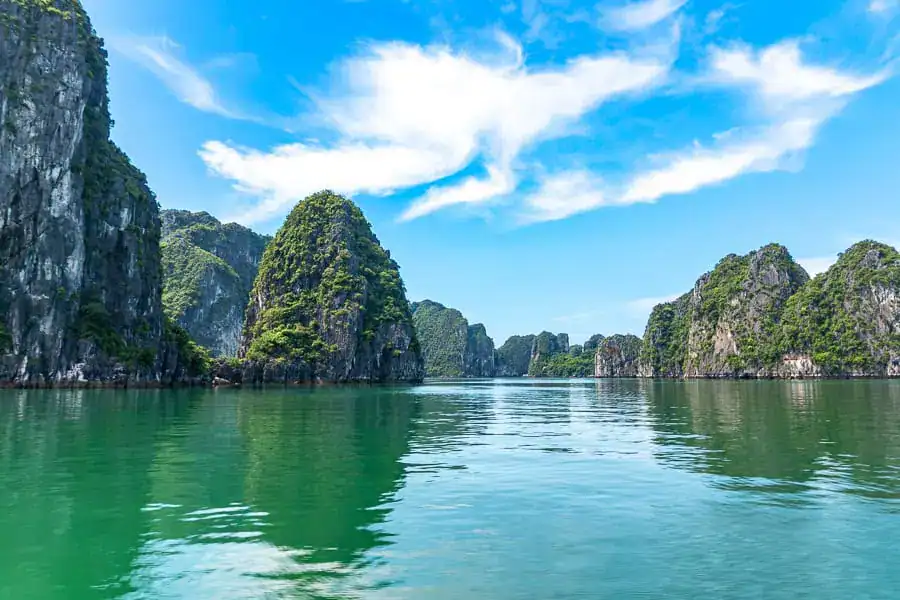 Limestone islands speckle the emerald waters off the northeastern coast of Vietnam – an area famous for Halong and Bai Tu Long Bay cruises.