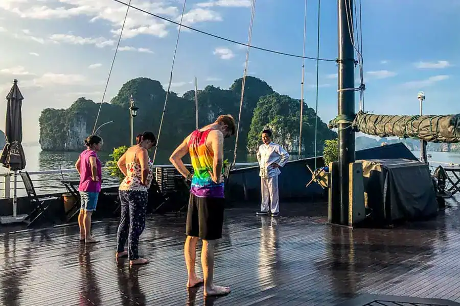 A group of passengers enjoy Tai-Chi in the early morning on our Bai Tu Long Bay cruise.