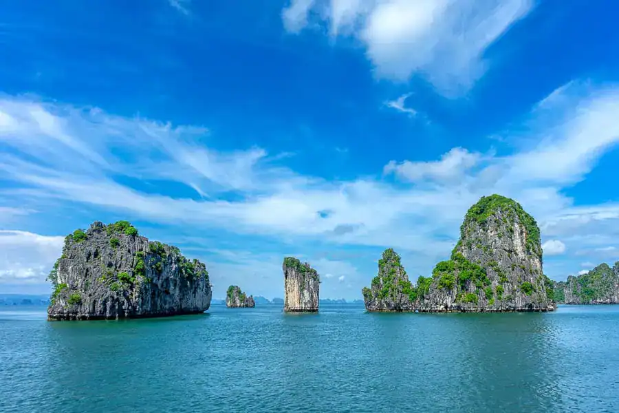 The limestone pinnacles of Halong Bay are stunning on a clear day, just be sure to cruise Halong Bay with a responsible operator.
