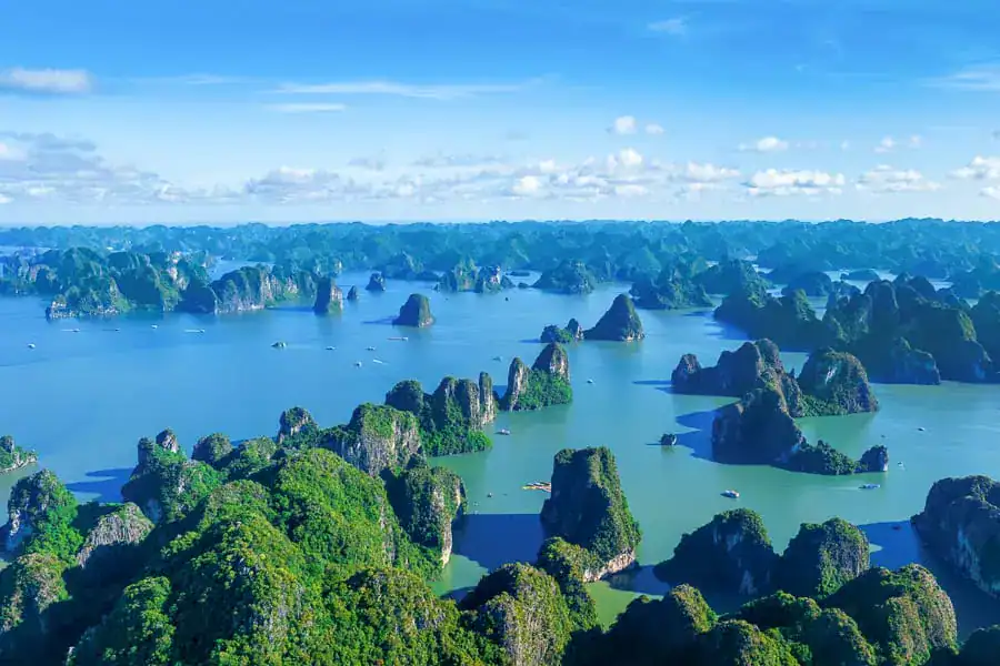 Areal view of the iconic karst landscape dotting the waters of Halong Bay in Vietnam.